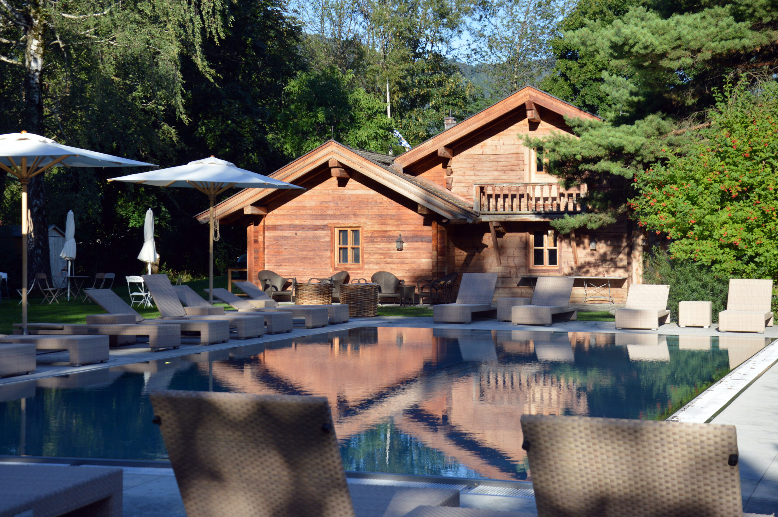 Sparkling resort swimming pool with loungers on a sunny day